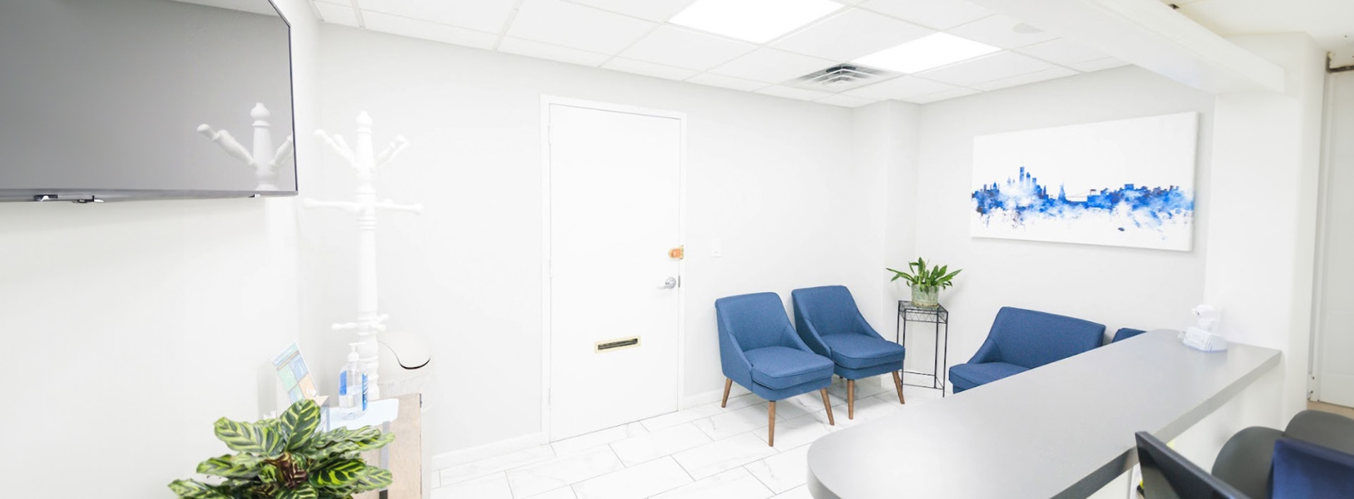 The image is a composite of two photos, showing an interior space that includes a waiting area with seating and a reception desk, and another photo capturing the same room from a different angle.