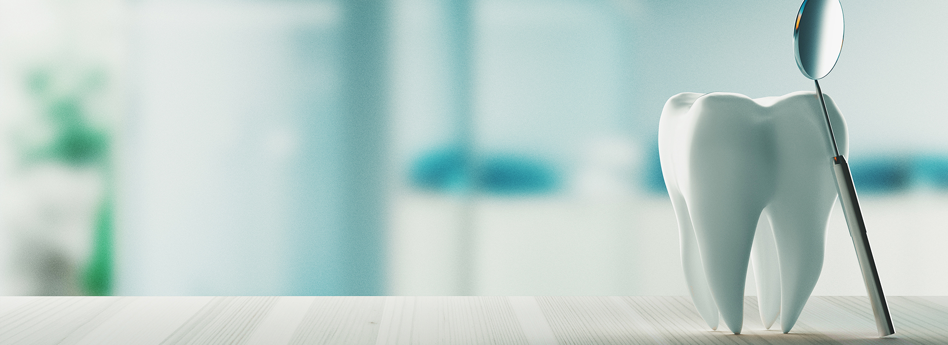 The image shows a toothbrush with bristles and a handle, placed on a surface with a blurred background that suggests an indoor setting.